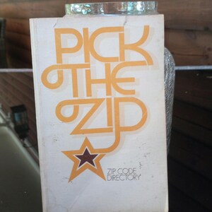 May include: A vintage book titled "Pick the Zip" with a yellow star and the text "Zip Code Directory".
