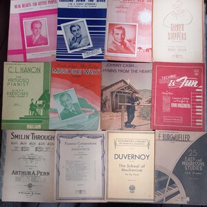 May include: A collection of vintage sheet music featuring various musical genres, including hymns, waltzes, and piano exercises. The covers feature illustrations of people, churches, and musical instruments.