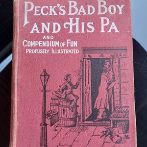 May include: A red book with the title "Peck's Bad Boy and His Pa and Compendium of Fun Profusely Illustrated" in white lettering. The cover features a black and white illustration of two people standing in a doorway.
