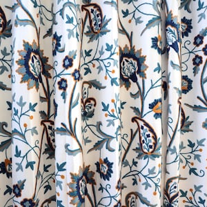 Crewel Hand Embroidered Fabric Blue & Rust sold by the yard. We can craft curtains to your specifications. Please contact us for a quote.