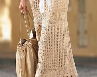 May include: A long, beige crochet skirt with a scalloped hem. The skirt is worn with a white blouse and a brown belt with silver accents.