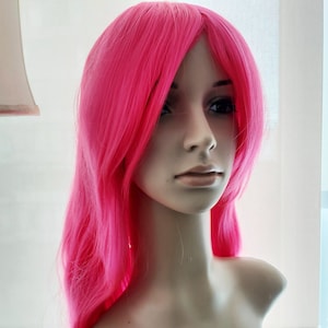 Hot pink long curly wig for women. Beautiful hot pink party costume hair. High quality synthetic hair. Free shipping in USA. Ready to ship.