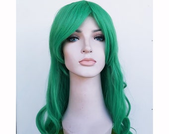 May include: A vibrant green wig with long, wavy hair and bangs, displayed on a neutral-toned mannequin head. The hair features a smooth texture and a consistent, bright emerald green color throughout the entire length of the style.
