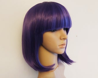 May include: A purple wig with a blunt cut and bangs. The wig is styled on a mannequin head.
