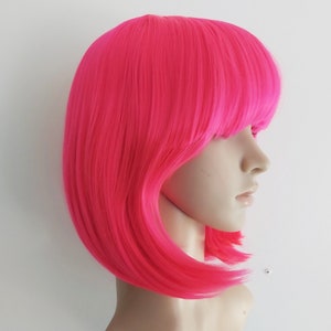 Hot pink bob wig with bangs for women. Hot pink straight short hair. High quality synthetic hair. Free USPS shipping in USA. Ready to ship.