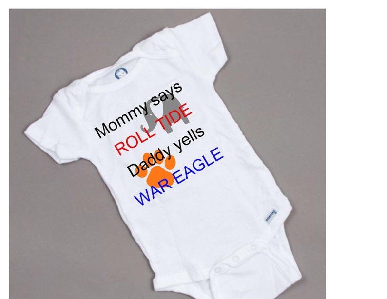 Mom says roll tide Daddy yells war eagle football baby onesie