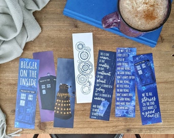 May include: Set of six blue and white bookmarks featuring Doctor Who themed illustrations and quotes. The bookmarks feature the TARDIS, a Dalek, and a quote about the universe.