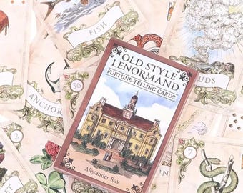 May include: A deck of Old Style Lenormand Fortune-Telling Cards with a brown box featuring a vintage illustration of a building. The box has gold accents and the text "Old Style Lenormand Fortune-Telling Cards" and "Alexander Ray".