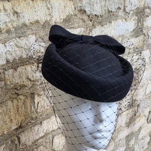 black pillbox hat with bow and black hat veil to front