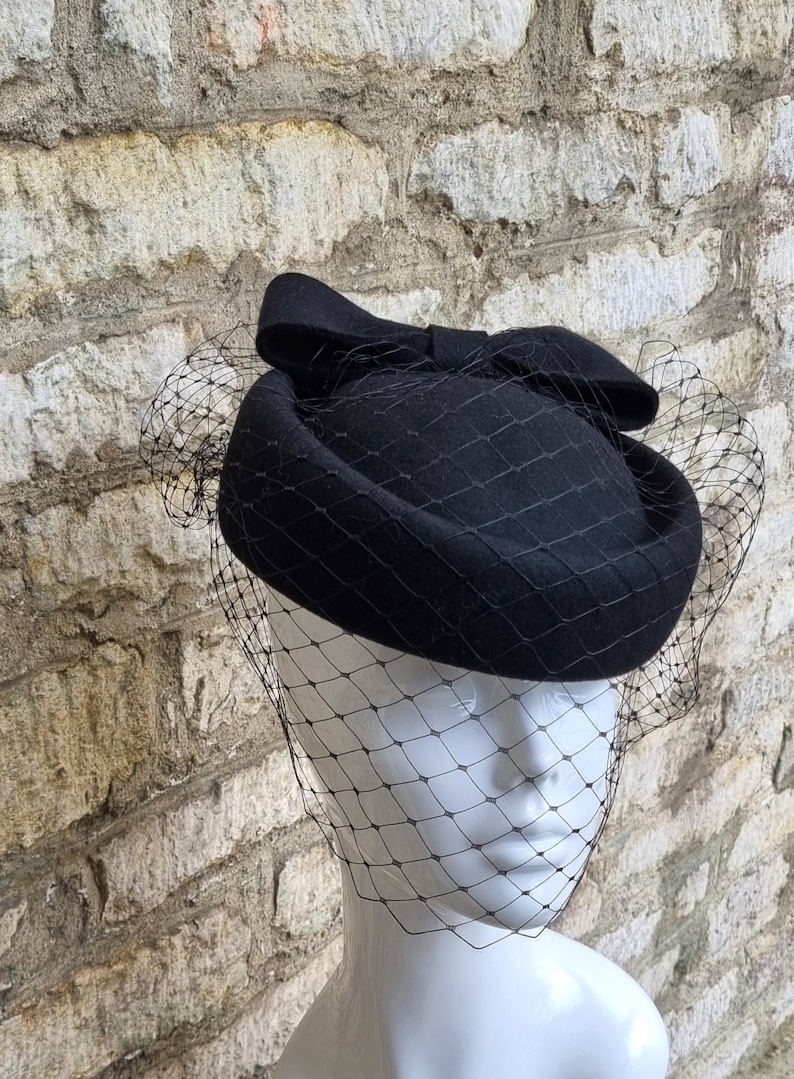 black pillbox hat with bow and black hat veil to front