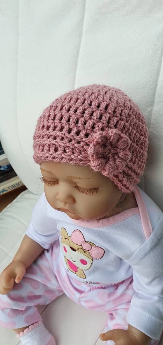 Bonnet au crochet pour bébé fille avec détail floral. Conception