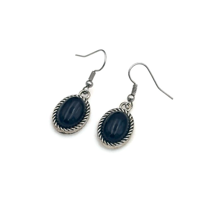 May include: A pair of silver earrings with black oval-shaped stones. The stones are set in a silver frame with a rope-like design.