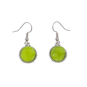 May include: A pair of silver dangle earrings with green round cabochon stones.