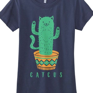 May include: A navy blue t-shirt with a green cat-shaped cactus in a yellow and green pot. The text "CATTUS" is printed below the cactus.