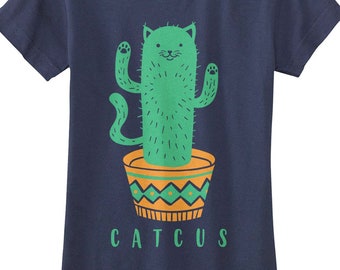 May include: A navy blue t-shirt featuring a green cat-shaped cactus in a yellow and green pot. The text "CATTUS" is printed below the cactus.