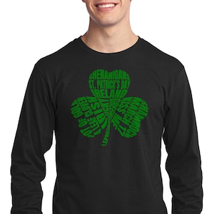 May include: Black long-sleeve t-shirt with a green shamrock design. The shamrock is made up of words related to St. Patrick's Day, including "Shenanigans", "St. Patrick's Day", "Ireland", "Pot of Gold", "4 Leaf Clover", "Leprechaun", "Irish", "Kiss Me", "March 17", "Shamrock".