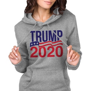 May include: Grey hooded sweatshirt with the text "TRUMP 2020" in blue and red lettering with a red, white and blue American flag graphic.