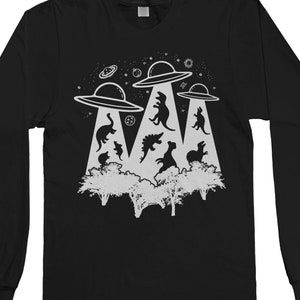 May include: Black long-sleeve t-shirt with a graphic of three UFOs abducting dinosaurs. The UFOs are white and the dinosaurs are black silhouettes.