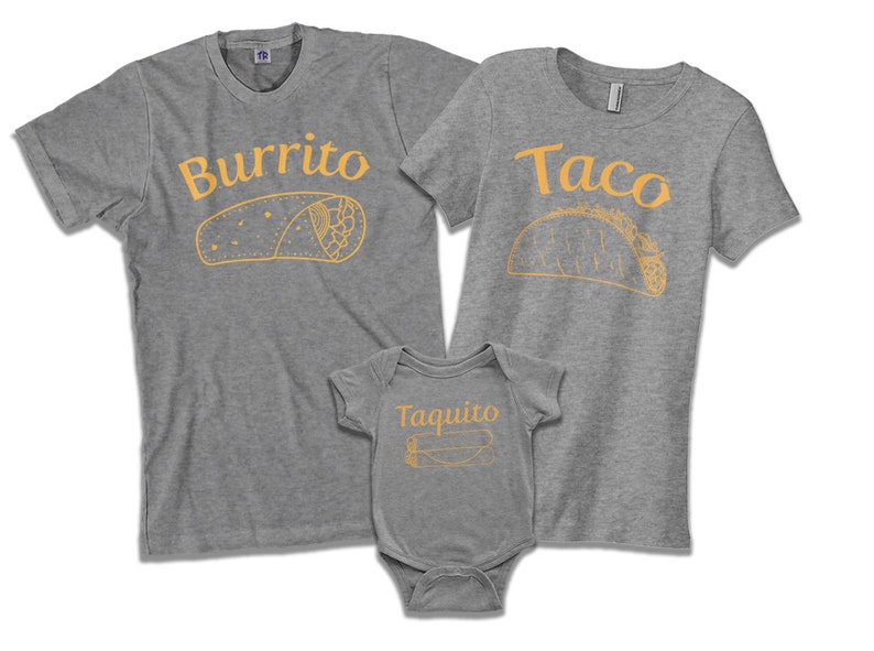 May include: A set of three gray t-shirts with a burrito, taco, and taquito design. The shirts have the words "Burrito", "Taco", and "Taquito" printed on them in orange.