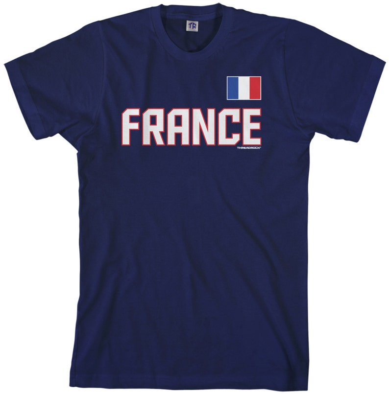 May include: A navy blue t-shirt with a white and red French flag and the word "FRANCE" in white letters with red outlines.