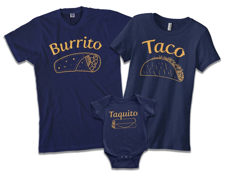 May include: A set of three navy blue t-shirts with a burrito, taco, and taquito design. The shirts have the words "Burrito", "Taco", and "Taquito" printed on them in a gold color.