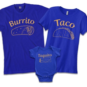 May include: A set of three blue t-shirts with a Mexican food theme. The largest shirt says "Burrito" with a drawing of a burrito. The medium shirt says "Taco" with a drawing of a taco. The smallest shirt says "Taquito" with a drawing of a taquito.