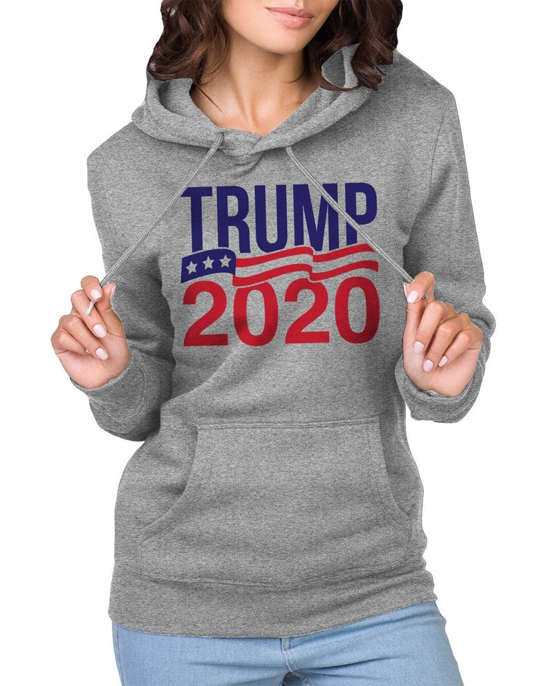 May include: Grey hooded sweatshirt with the text "TRUMP 2020" in blue and red lettering with a red, white and blue American flag graphic.
