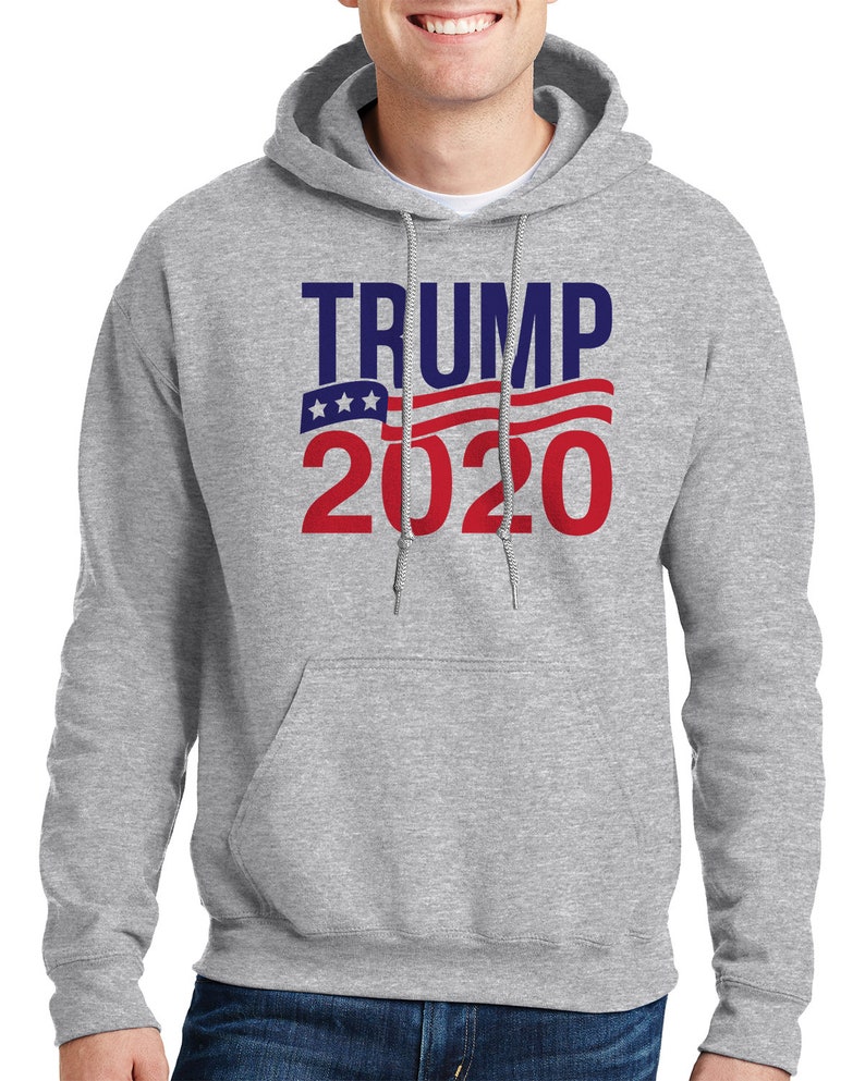 May include: A grey hooded sweatshirt with the text "TRUMP 2020" in red and blue lettering. The text is overlaid with a red, white and blue American flag design.