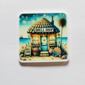 May include: Square image of a whimsical "Shell Shop" on a beach. The shop has a thatched roof, blue door, and a sign. Seashells and a palm tree are also visible. The shop is set against a backdrop of a blue sky and ocean.