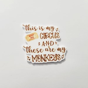 May include: A brown and white sticker with the text "This is my circus and these are my monkeys." The sticker features a small illustration of an admission ticket.