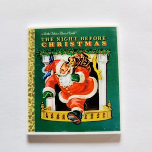May include: A vintage Little Golden Book with a green cover featuring an illustration of Santa Claus carrying a bag of toys down a chimney. The book title is "The Night Before Christmas".