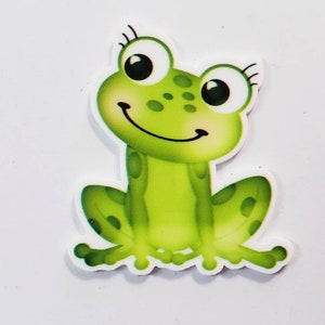 May include: A green cartoon frog with big eyes and a smile. The frog has white spots and is sitting on a white background.