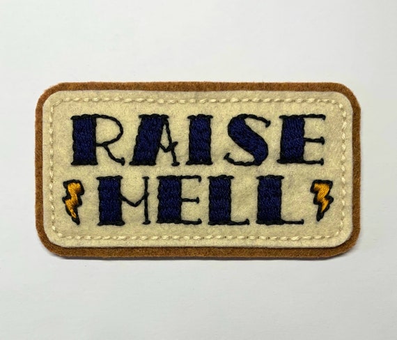 'Raise Hell' tattoo lettering with bolts patch