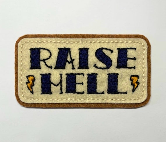 'Raise Hell' tattoo lettering with bolts patch