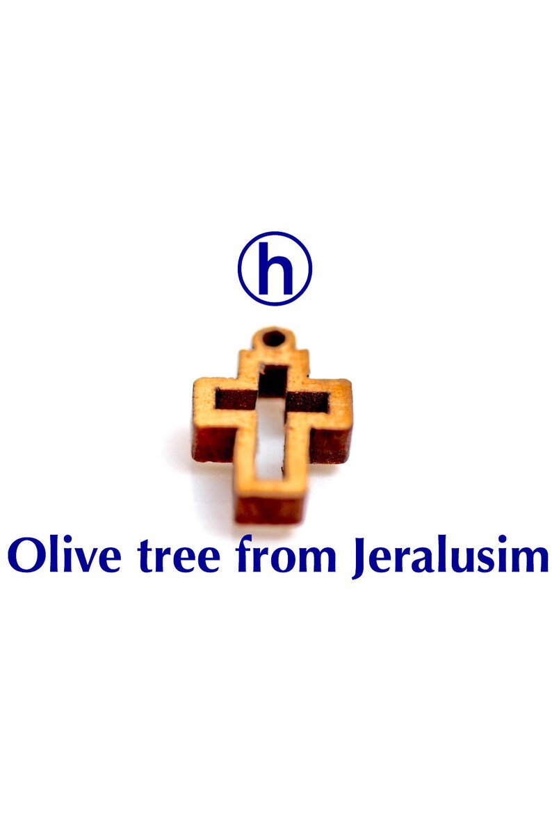 May include: A small wooden cross made from olive wood from Jerusalem. The cross is a simple design with a hole at the top for hanging.