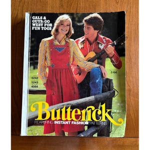 May include: A vintage Butterick pattern book cover featuring a man playing a guitar and a woman in a red dress. The cover has the text "GALS & GUYS: GO WEST FOR FUN TOGS" and "Butterick FEATURING INSTANT FASHION PATTERNS".