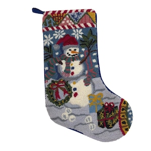 May include: A festive Christmas stocking with a snowman motif. The blue stocking displays a snowman in a red hat and scarf, with snowflakes, a wreath, and presents. The top edge has a colourful geometric pattern.
