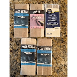 May include: Five packages of Wrights sewing notions including four packs of beige seam binding and one pack of Flexi-Lace hem tape. Each package contains 3 yards of material. The packaging features black, blue, and pink labels with product text.