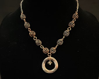 Bronze beaded necklace with bronze pendant and crystal