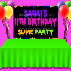 May include: A party scene with a bright green tablecloth and a black backdrop that reads "SANAI'S 11TH BIRTHDAY SLIME PARTY" in neon colors. Colorful balloons in red, yellow, purple, and green are tied to the sides.