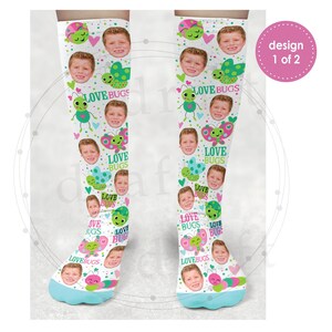 May include: A pair of white knee-high socks with a colorful pattern of ladybugs, butterflies, and hearts. The socks feature the text "Love Bugs" repeated throughout the design.
