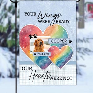 May include: A garden flag with a watercolour heart design, featuring a photo of a golden retriever named Cooper. The flag includes the text "Your Wings Were Ready; Our Hearts Were Not" and paw prints.