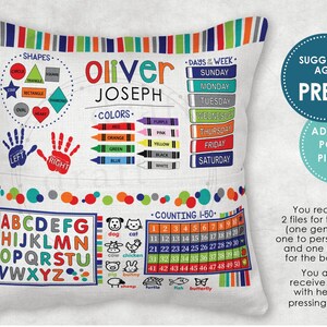 May include: A white pillow with colourful borders and a variety of educational content for preschoolers. The pillow features a colourful alphabet, shapes, colours, days of the week, and numbers 1-50. The pillow is personalised with the name "Oliver Joseph" and the suggested age is "Pre-K".