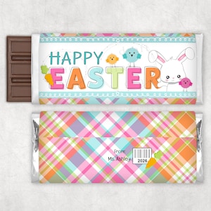 May include: A chocolate bar with a colorful Easter-themed wrapper. The wrapper features the words "HAPPY EASTER" in bright letters, along with a white bunny and small birds. The back of the wrapper has a plaid pattern.