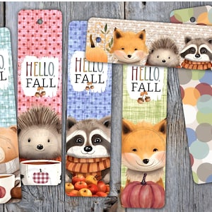 May include: Set of six colourful bookmarks featuring different woodland animals, including a fox, raccoon, hedgehog, and bear. Each bookmark has a "Hello Fall" greeting and an autumn-themed design.