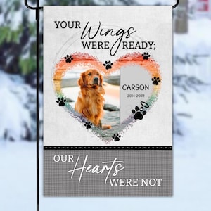 May include: A garden flag with a photo of a golden retriever inside a heart-shaped design. The flag includes the text "YOUR Wings WERE READY; OUR Hearts WERE NOT" and the name "CARSON" with the years 2014-2022.