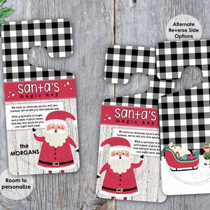 May include: A black and white checked door hanger with a Santa Claus illustration and the text "Santa's magic key". The text reads: "We have no chimney, so you will see, Instead, we've left you this special key. With a sprinkle of magic and a dash of good cheer, this key will work for you one night each year. The [name]"