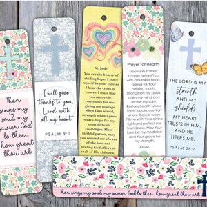 May include: A collection of Christian-themed bookmarks with floral and cross designs. Each bookmark features inspirational quotes and prayers. The color palette includes pink, blue, and yellow, with decorative floral patterns.