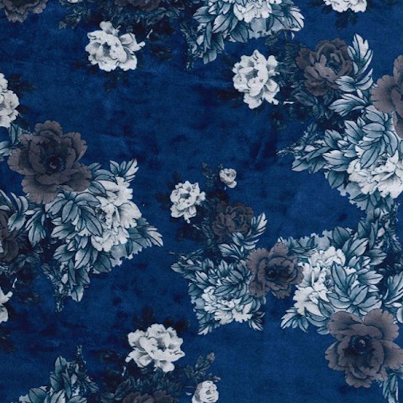 May include: A blue fabric with a white and gray floral pattern. The fabric has a soft, velvety texture.