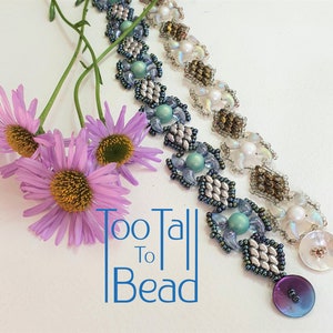 May include: A beaded bracelet with a silver, blue, and white color scheme. The bracelet features a geometric pattern and a large, iridescent purple button.